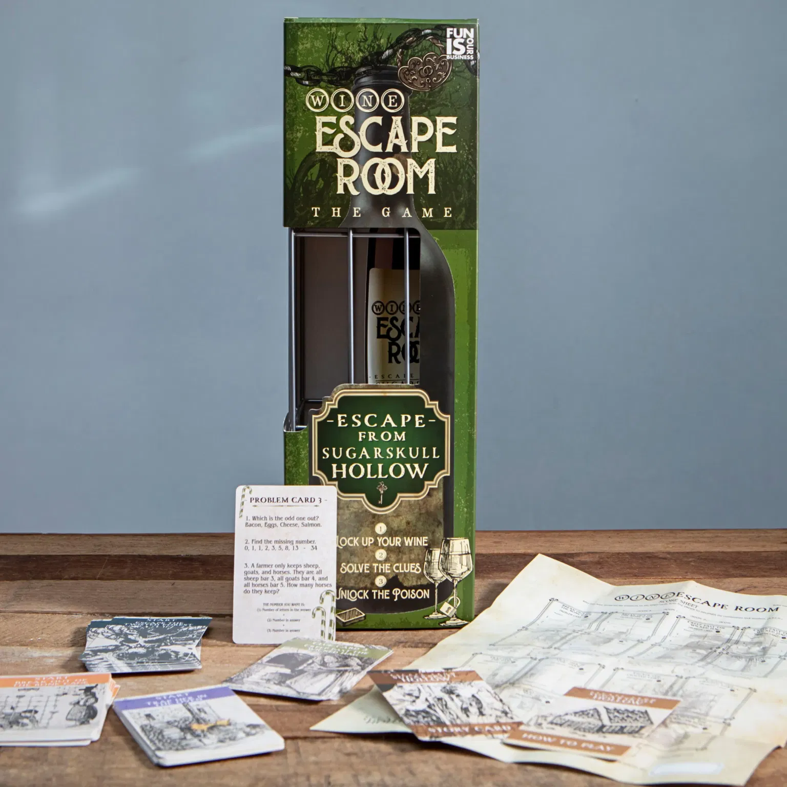 The Wine Escape Room game box titled 'Escape from Sugarskull Hollow' is displayed next to problem cards, a dice, and a map. The bottle lock is visible in the box window. Ideal novelty wine gift, party game, or fun activity for a couple.