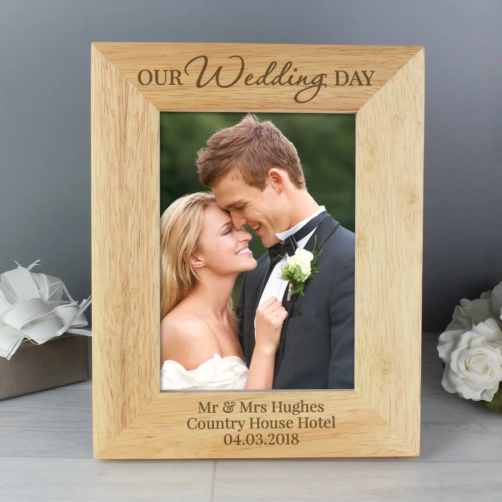 Personalised 'Our Wedding Day' Wooden Photo Frame in walnut wood, holding a 5×7 photo. Engraved with 'Mr & Mrs Hughes' and wedding date.