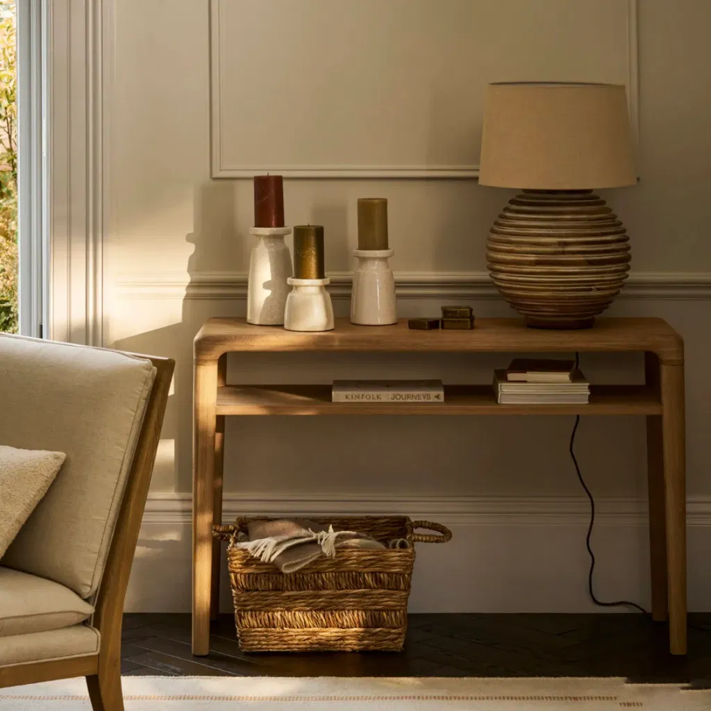 Solid oak console table with clean, minimalist lines, featuring long tapered legs and a smooth top surface, ideal for an entryway or hallway, styled in a bright, modern interior.