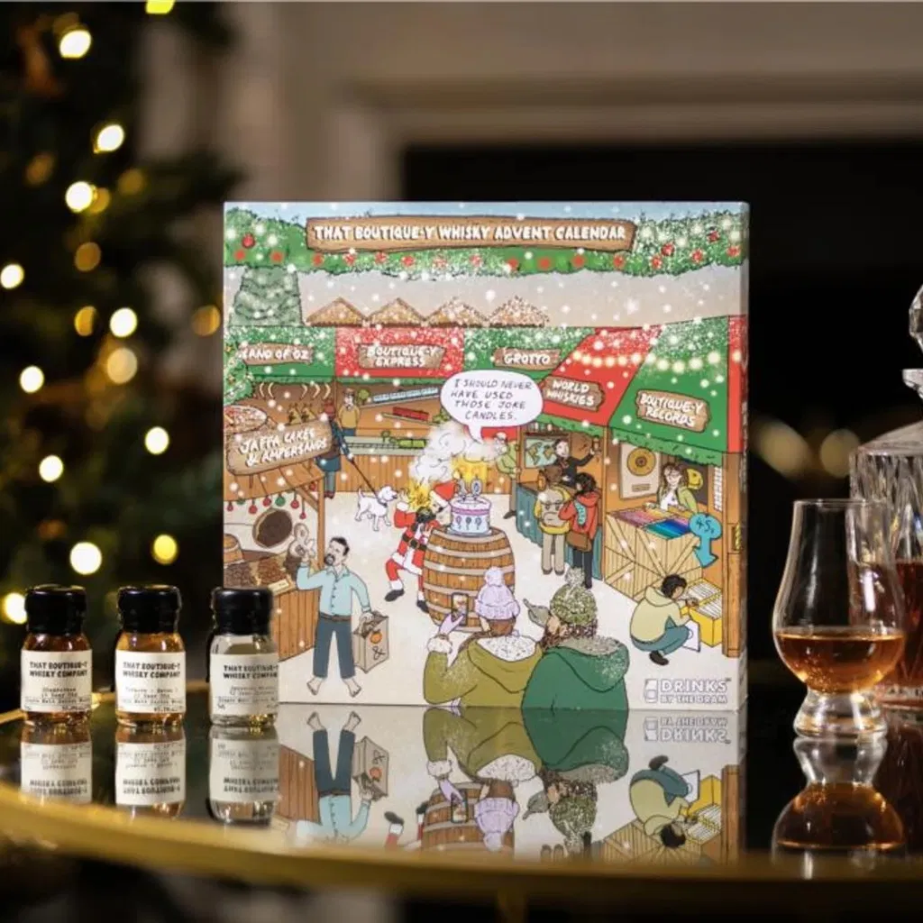 That Boutique-y Whisky Company Advent Calendar, a premium box featuring 24 wax-sealed drams of single malt and blended whiskies, displayed in a sophisticated, dark-colored presentation.