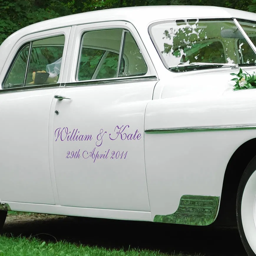 Personalised purple vinyl decal featuring names 'William & Kate' and a wedding date applied to the side door of a white vintage classic car.