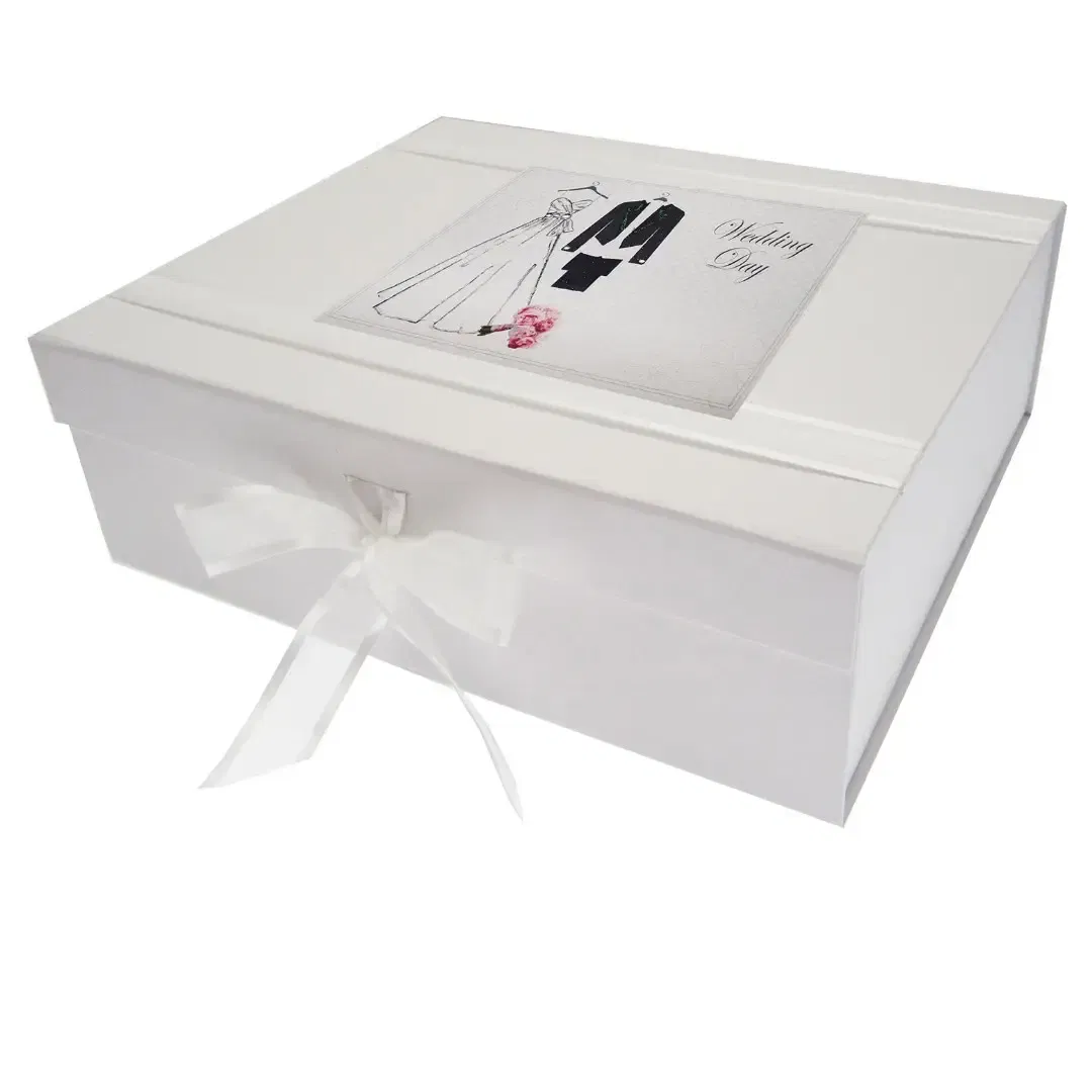 Large white 'Bride and Groom' wedding keepsake box featuring an illustration of a wedding dress and suit, handmade in England with a white organza ribbon tie.