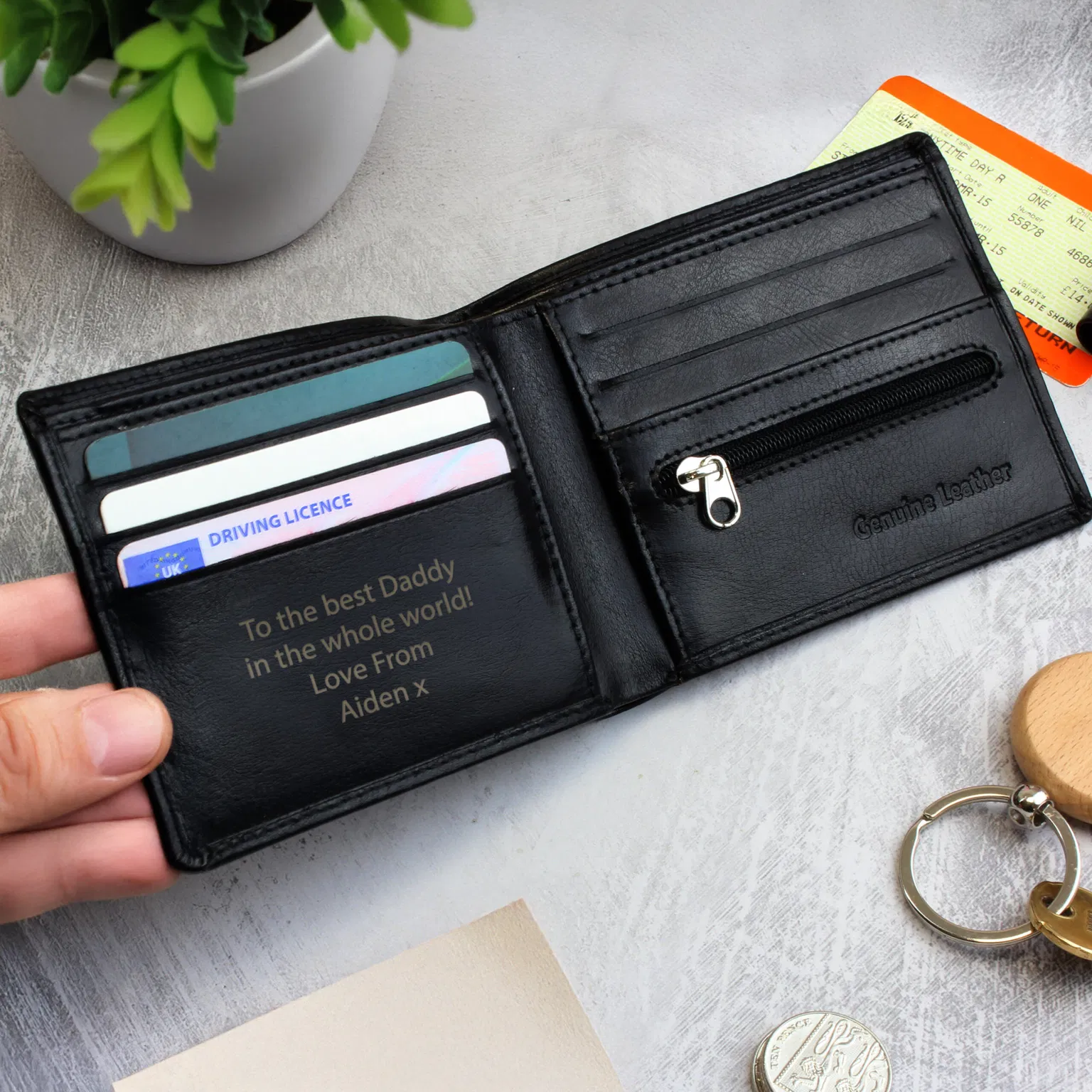 Personalised Black Leather Wallet: A professional photo of a sleek black leather bi-fold wallet. The engraving is clearly visible on the bottom corner, showcasing the custom initials against the smooth black leather finish.
