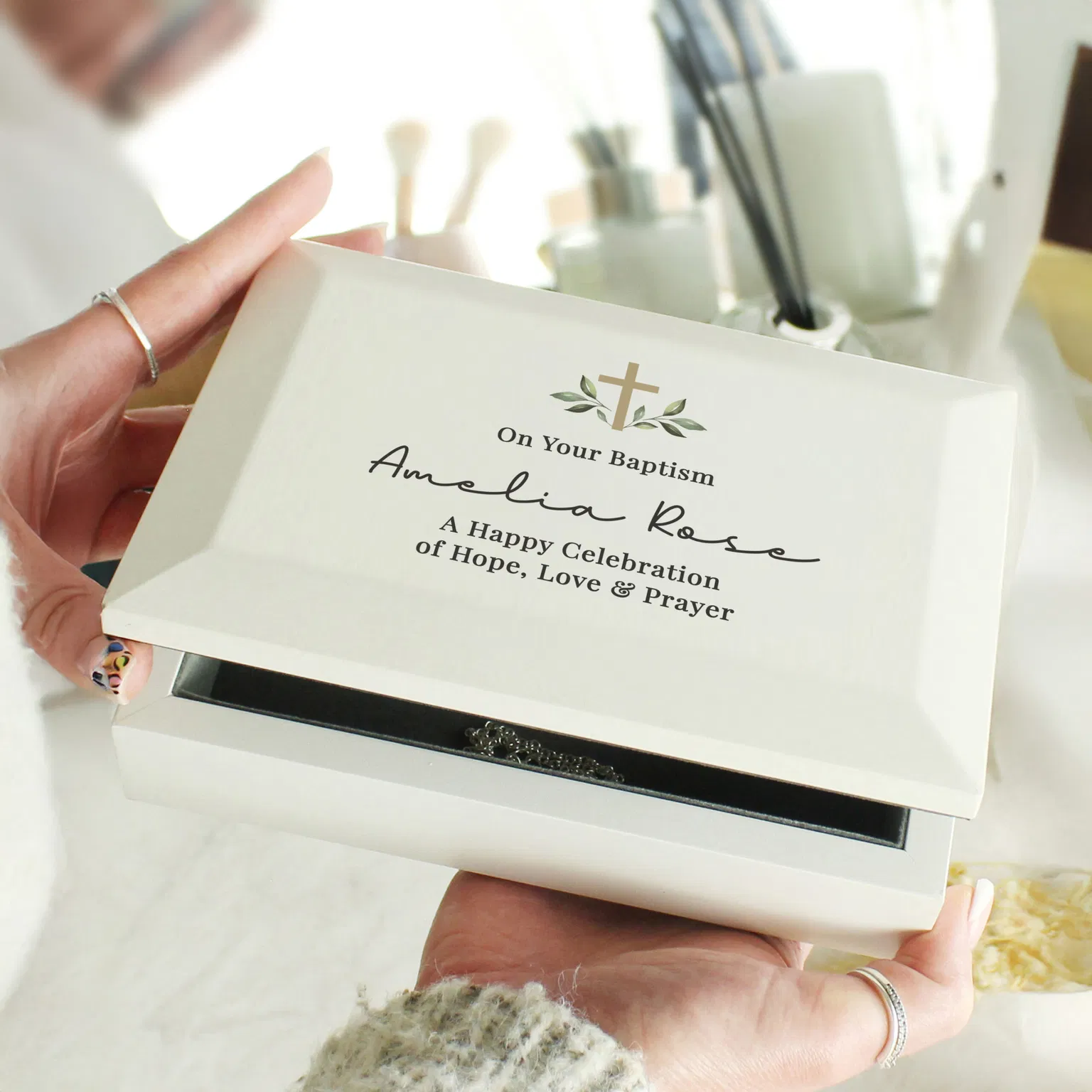 Personalised white Baptism jewellery box for Amelia Rose held in hands.