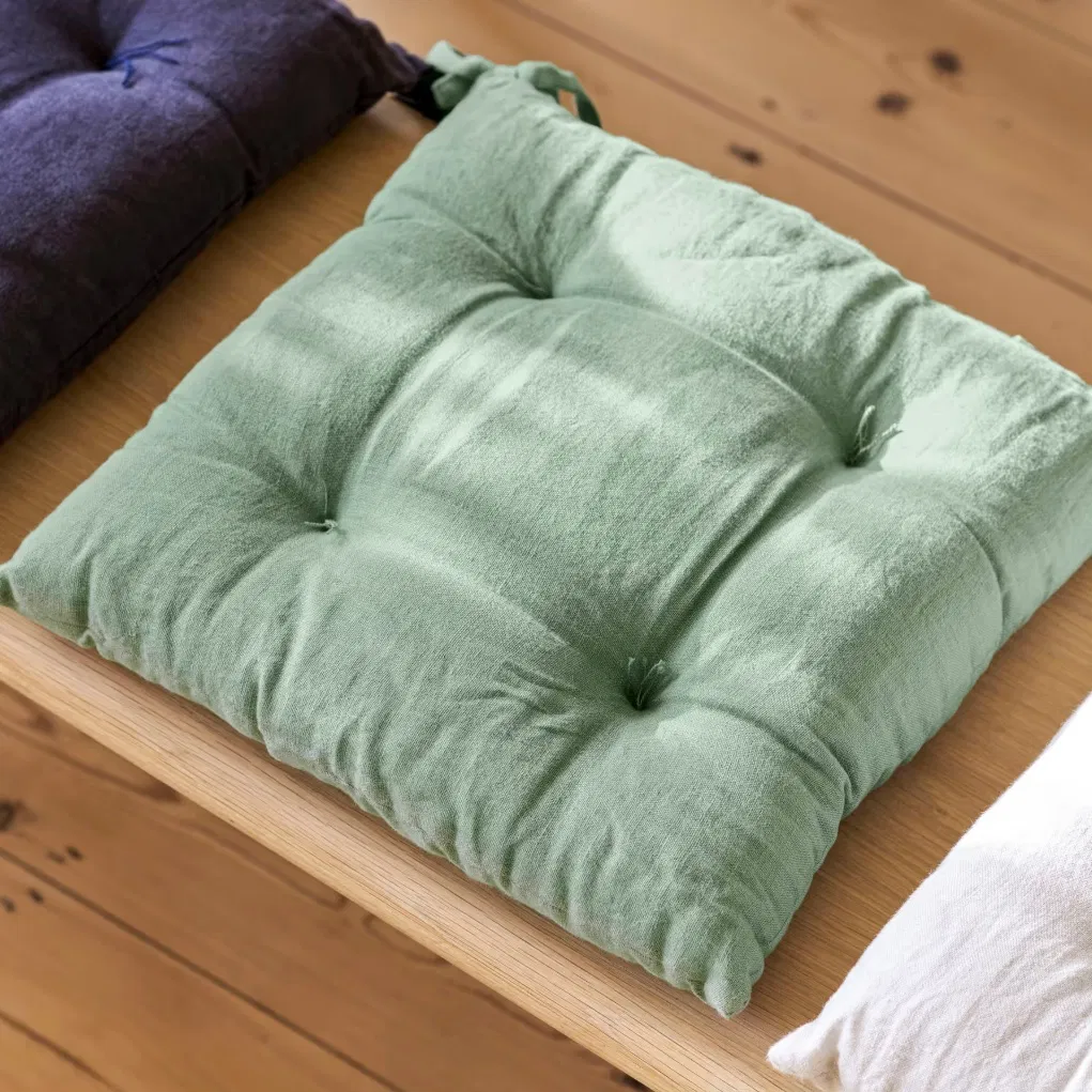 A top-down view of the Rosemary green quilted seat pad.