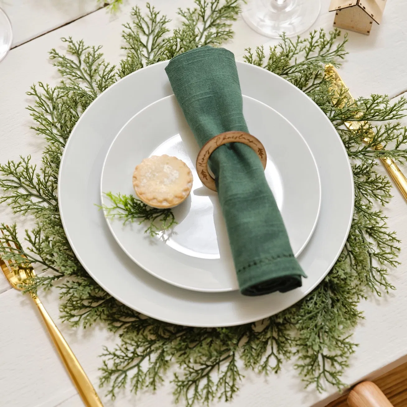 Set of Four Evergreen Foliage Place Mats styled with a white plate and green napkin on a rustic table.