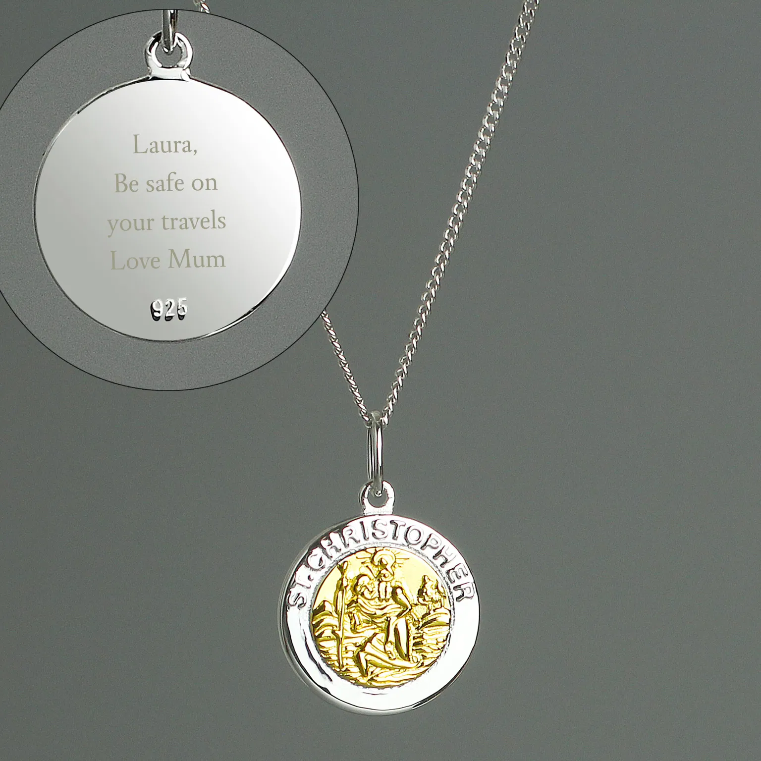 A sterling silver and 9ct gold-plated St. Christopher pendant necklace by Abode Home & Gifts on an 18-inch chain against a grey background. An inset circle highlights the engraved reverse side with the message "Laura, Be safe on your travels Love Mum" and a 925 sterling silver hallmark.