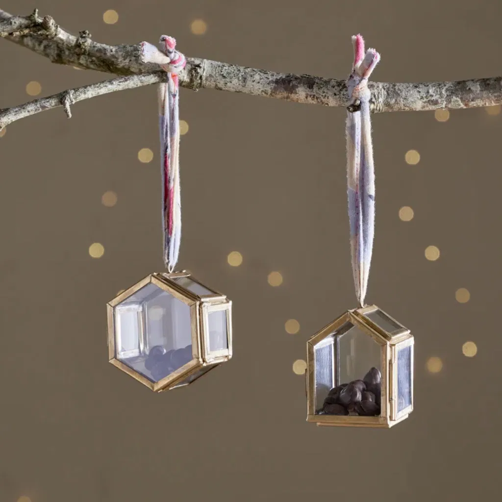 Set of two Malvern tiny brass and glass box ornaments hanging from a rustic branch with colorful sari silk ties.